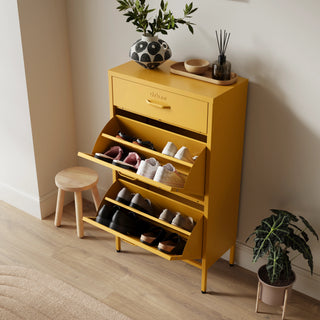 The Shoreditch shoe cabinet in mustard with a top drawer, two lower shoe compartments and matching handles, styled in a hallway.